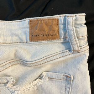american eagle light wash very ripped skinny jeans!